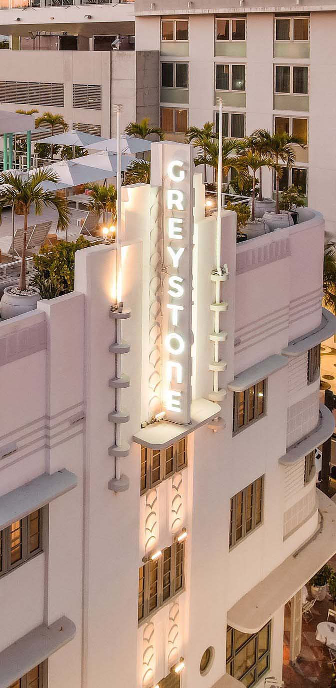 Greystone Facade from Bird Eye View by Night with Focus on Greystone Neon Sign