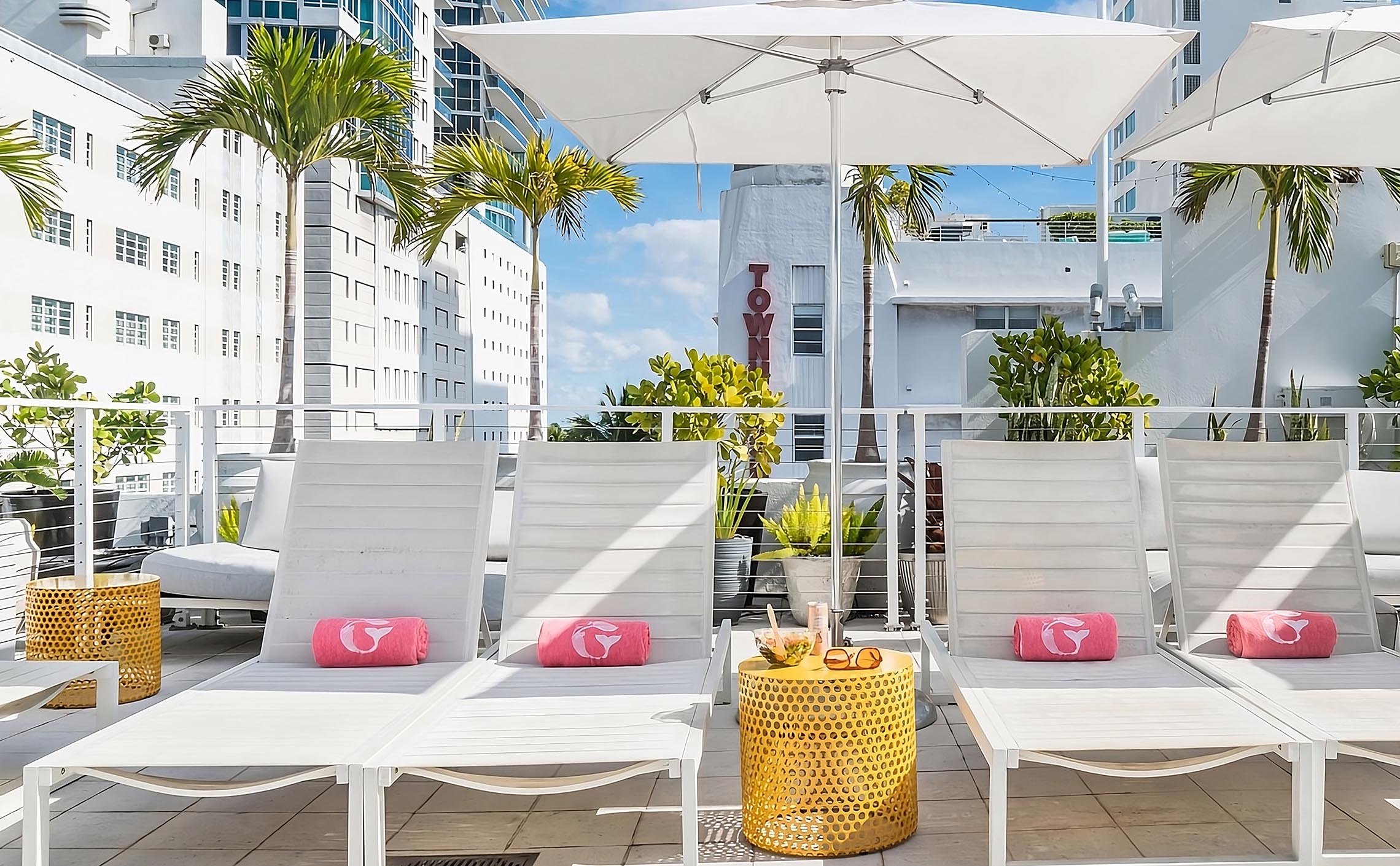 Lounge Chairs on the Gresytone Rooftop with pink towels branded with a white emrbroidered Gresytone Mermaid