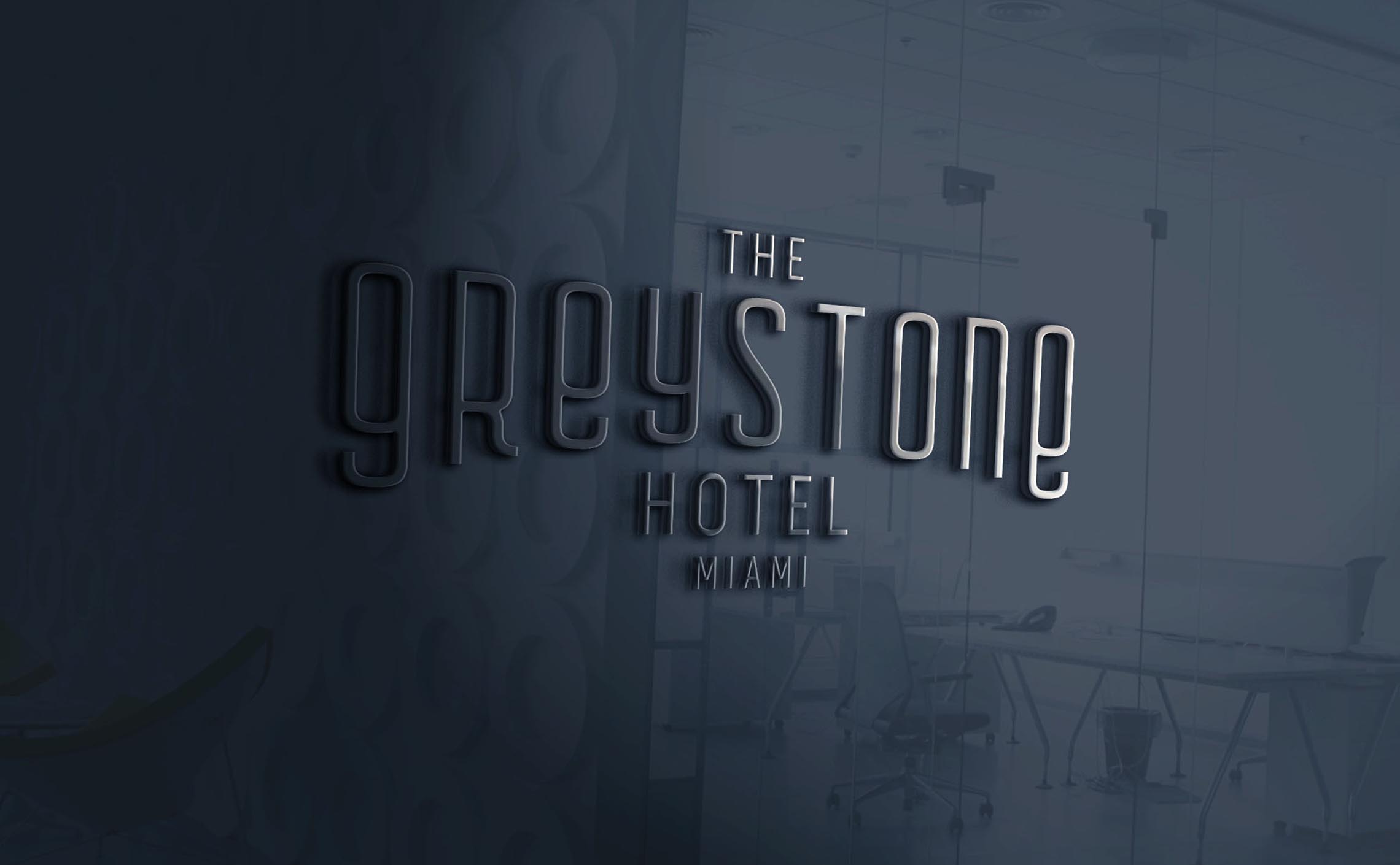 Unused alternative Greystone logo in a Art Deco Streamline era style with a symmetry of the initial G and the last E displayed as a mockup on a glass wall