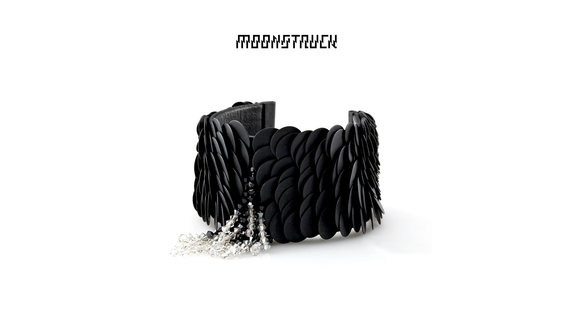 Photo of black collar refined with jewels with the Moonstruck logo above.