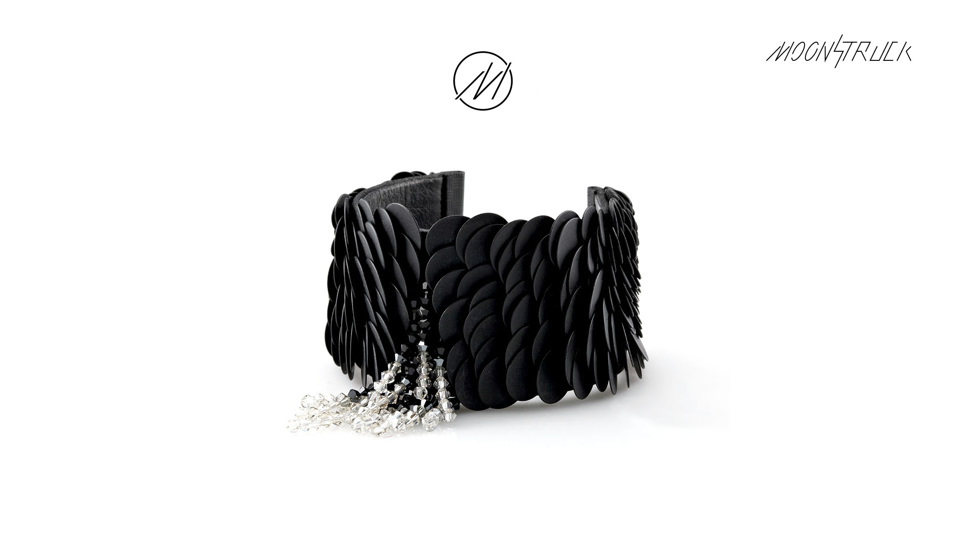 Photo of black collar refined with jewels with the Moonstruck logo above.